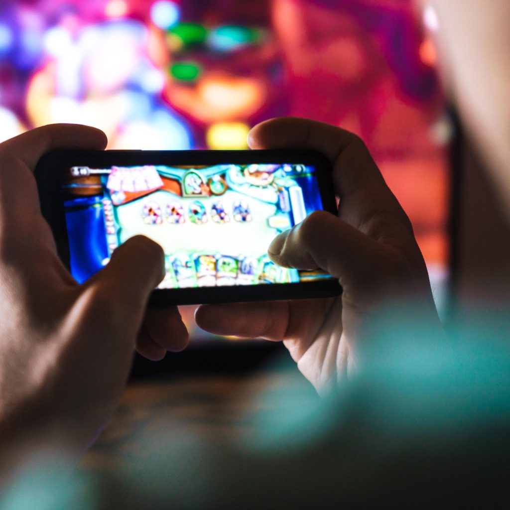 Image of Focused Man playing Mobile Game