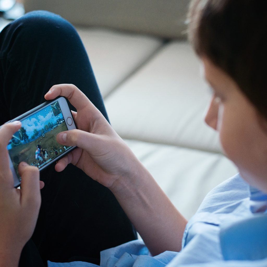 Boy Playing Game using Mobile