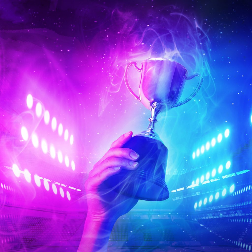 Trophy with smoke effect holding on hand and background blue and violet light for e-sport winner event